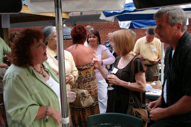 Debby Root chats with Bob McCartney, as Kathy Rimpela looks on